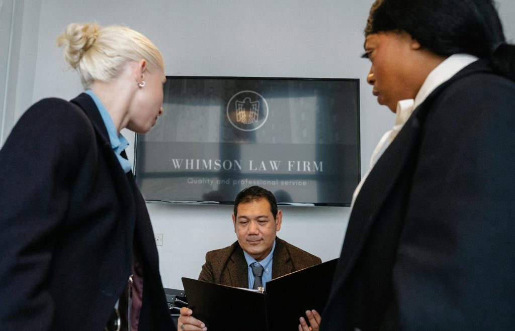 A diverse team of Legal Advisory Group attorneys collaborating around a conference table in a modern law office