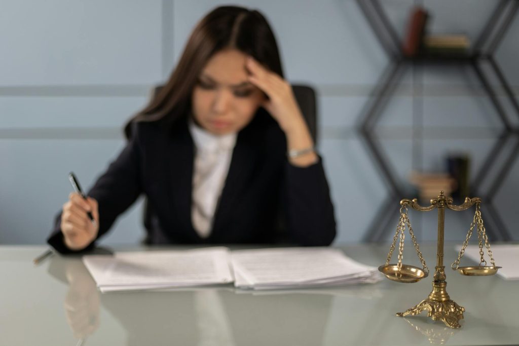 A confident legal professional seated at a polished office desk, conveying trust and expertise at Legal Advisory Group